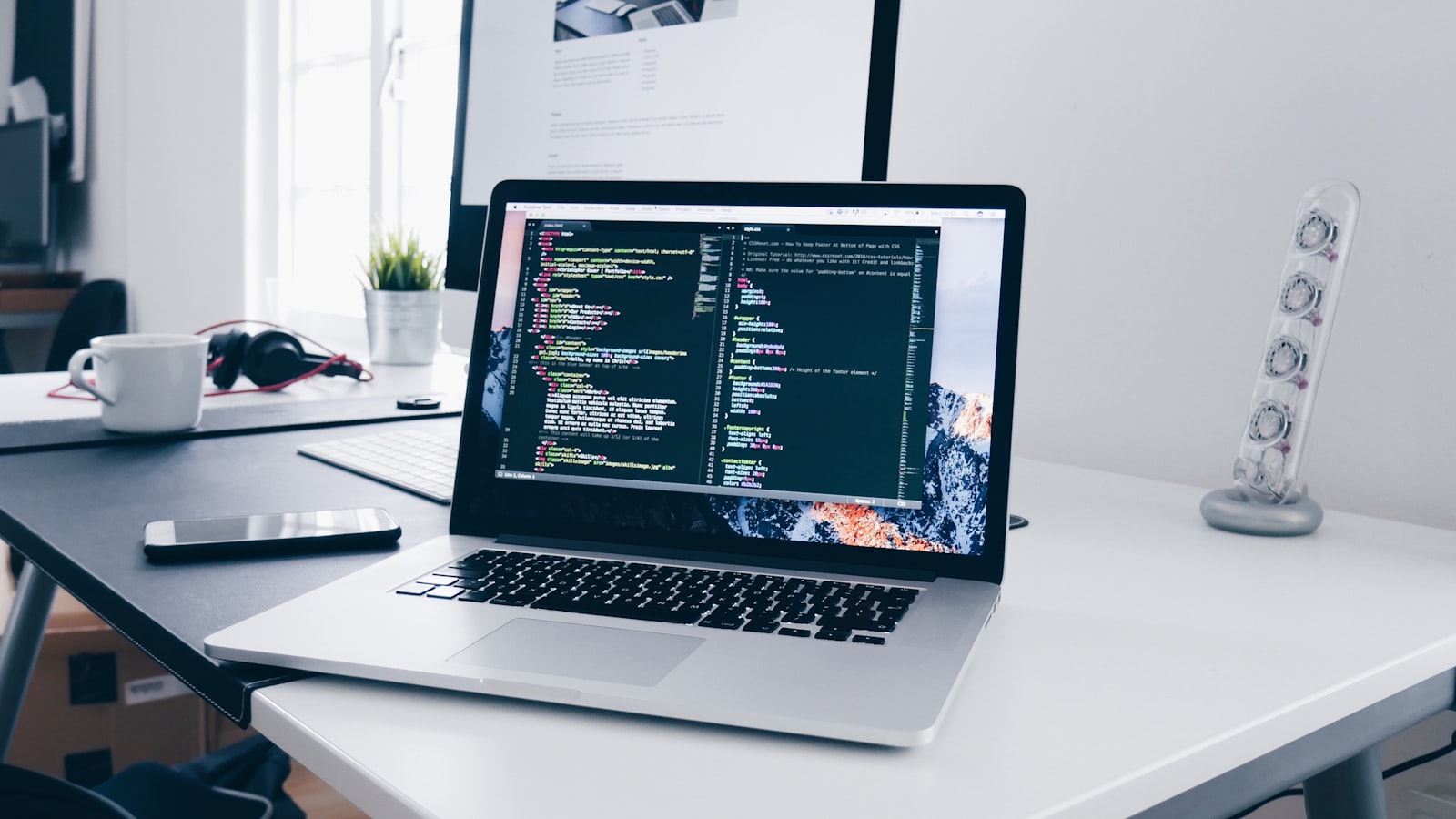 A tidy desk with a laptop showing a calendar and task list side by side