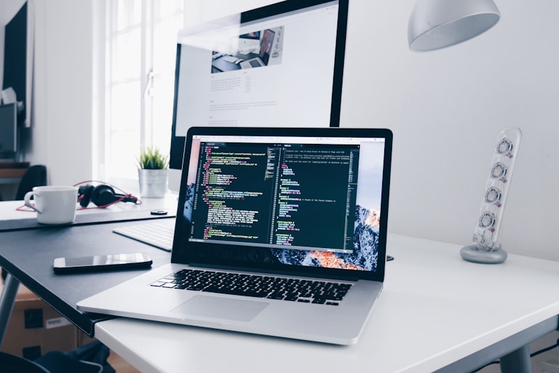 A tidy desk with a laptop showing a calendar and task list side by side