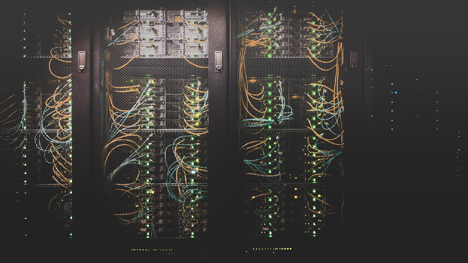 Rows of server racks glowing in a dim data center aisle